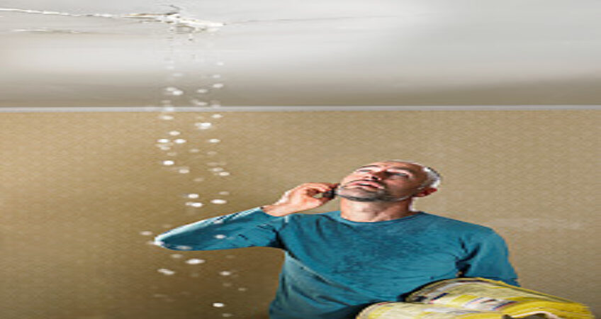 Man with a leaking ceiling using phone